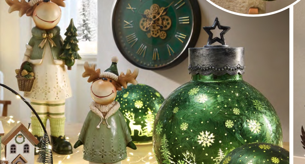 Festive moose figurines and glowing green ornaments with snowflake patterns create a cozy holiday atmosphere.